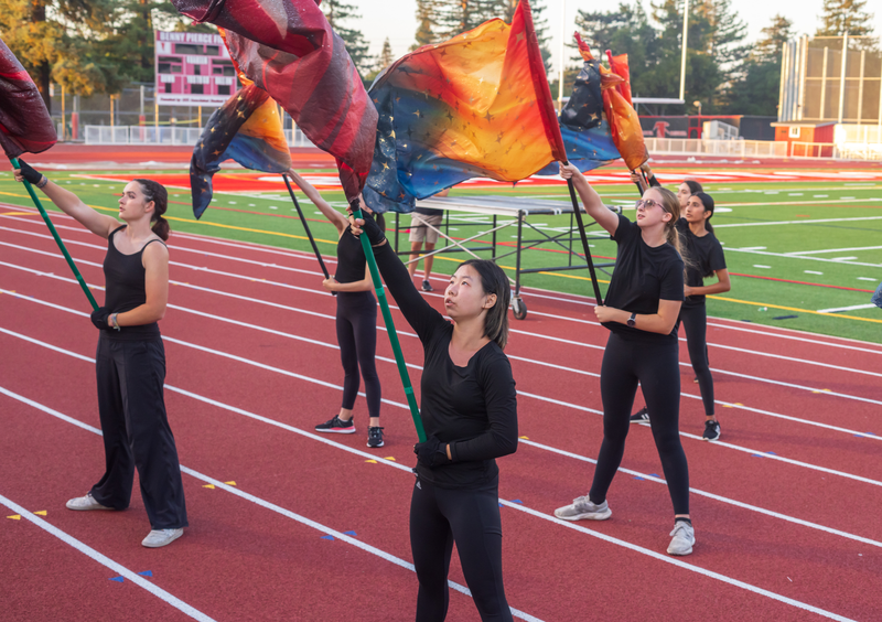 Saratoga color guard students performing with flags