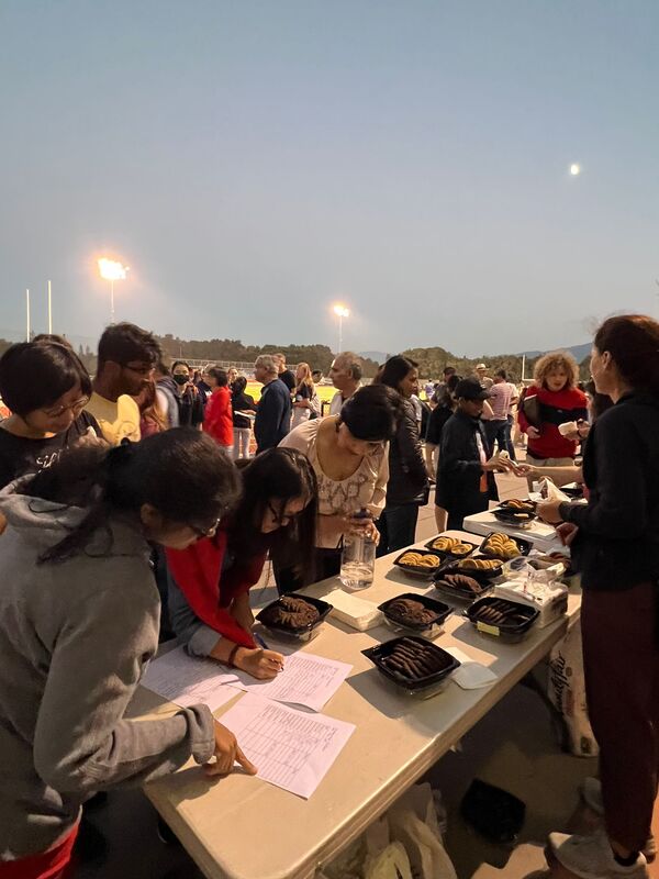 Volunteers assisting families at a Saratoga music event